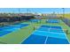 Aerial view of vibrant blue and green pickleball courts in a residential community at 3869 Consolare Ct, Wesley Chapel, FL 33543