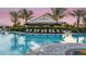 Poolside Bahama Bar with plenty of seating and lounge chairs in a beautiful community setting at 3869 Consolare Ct, Wesley Chapel, FL 33543