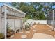 Relaxing backyard featuring a pergola, mature landscaping, and stepping stones at 4012 N Munro St, Tampa, FL 33603