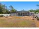 Large backyard featuring a screened pool, a fire pit area, and mature trees at 4012 N Munro St, Tampa, FL 33603