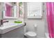 Charming bathroom featuring a unique mirror, pineapple wallpaper, and bright pink shower curtain at 4012 N Munro St, Tampa, FL 33603