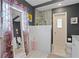 Bathroom with a dual vanity, granite countertop, and walk-in shower with updated fixtures at 4012 N Munro St, Tampa, FL 33603
