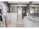Bathroom with a dual vanity, granite countertop, and walk-in shower with updated fixtures at 4012 N Munro St, Tampa, FL 33603