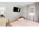 Peaceful bedroom with a comfortable bed, soft lighting, and view to the hallway and living area at 4012 N Munro St, Tampa, FL 33603