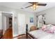 Inviting bedroom featuring a four-poster bed, ceiling fan, and warm natural light at 4012 N Munro St, Tampa, FL 33603