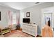 Bright bedroom with a large dresser, soft pink accents, and a view of the yard at 4012 N Munro St, Tampa, FL 33603