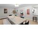 Bright dining room features a long table with chairs, a stylish light fixture and vibrant decor at 4012 N Munro St, Tampa, FL 33603