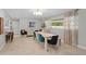 Spacious dining room featuring modern decor, stylish seating, and a view of the yard at 4012 N Munro St, Tampa, FL 33603