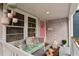 Inviting front porch with comfortable seating and pink accents, creating a cozy and stylish entrance at 4012 N Munro St, Tampa, FL 33603