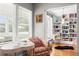 Inviting library nook with floor-to-ceiling bookshelves, a cozy chair, and sunlit windows for reading at 4012 N Munro St, Tampa, FL 33603