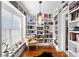 Charming library nook bathed in natural light, featuring floor-to-ceiling bookshelves and a cozy chair at 4012 N Munro St, Tampa, FL 33603