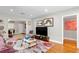 Cozy living room features hardwood floors, bright artwork, and seamless transitions into other living spaces at 4012 N Munro St, Tampa, FL 33603