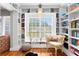 Cozy reading nook with built-in bookshelves, hardwood floors, and a window seat with natural light at 4012 N Munro St, Tampa, FL 33603