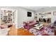 Open-concept living room with hardwood floors, seamless transitions, and stylish furnishings for a comfortable lifestyle at 4012 N Munro St, Tampa, FL 33603