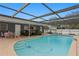 Covered pool with patio furniture and greenery, creating a serene outdoor living space at 4012 N Munro St, Tampa, FL 33603