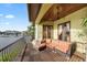 Spacious balcony with outdoor seating, wood flooring, and waterfront views at 4128 Causeway Vista Dr, Tampa, FL 33615