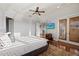 Bright bedroom boasts hardwood floors, natural light, and private balcony access at 4128 Causeway Vista Dr, Tampa, FL 33615