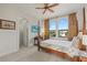 Light-filled bedroom with large windows, hardwood bed frame, and custom curtains at 4128 Causeway Vista Dr, Tampa, FL 33615