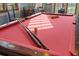 Close up of billiard table featuring red felt, pool cues and pool balls at 4128 Causeway Vista Dr, Tampa, FL 33615