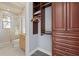 Walk-in closet features custom cabinetry and shelving, conveniently located next to the bathroom at 4128 Causeway Vista Dr, Tampa, FL 33615