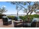 Inviting deck area with comfortable wicker seating, perfect for relaxing and enjoying serene water views at 4128 Causeway Vista Dr, Tampa, FL 33615
