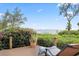 Relaxing deck area with comfortable lounge chair, lush greenery, and scenic water views for tranquil outdoor enjoyment at 4128 Causeway Vista Dr, Tampa, FL 33615