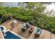 Spacious outdoor deck with outdoor seating and a pool with lush landscaping at 4128 Causeway Vista Dr, Tampa, FL 33615