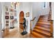 Grand entryway featuring decorative statue, wood door, tiled floor, and staircase at 4128 Causeway Vista Dr, Tampa, FL 33615