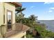 Exterior shot with a balcony, showcasing a view of the waterway and lush landscaping at 4128 Causeway Vista Dr, Tampa, FL 33615