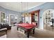 Entertaining game room featuring a billiard table, a fireplace and a bar area at 4128 Causeway Vista Dr, Tampa, FL 33615