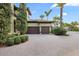 Large two-car garage and paved driveway with lush landscaping at 4128 Causeway Vista Dr, Tampa, FL 33615