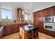 Gourmet kitchen featuring stainless steel appliances, granite counters, and an island at 4128 Causeway Vista Dr, Tampa, FL 33615