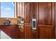 A kitchen featuring wood cabinets and a stainless steel refrigerator with a water dispenser at 4128 Causeway Vista Dr, Tampa, FL 33615