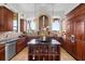 Kitchen with custom cabinetry, marble countertops, and stainless-steel appliances at 4128 Causeway Vista Dr, Tampa, FL 33615