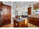 Spacious kitchen featuring an island, granite countertops, and elegant lighting fixtures at 4128 Causeway Vista Dr, Tampa, FL 33615