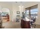 Another view of the office featuring built in cabinets and a view to other living spaces at 4128 Causeway Vista Dr, Tampa, FL 33615