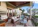 Outdoor patio seating area with ceiling fan, grill, and views of the pool and waterfront at 4128 Causeway Vista Dr, Tampa, FL 33615