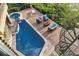 Aerial view of a pool with a hot tub and lounge area surrounded by lush greenery at 4128 Causeway Vista Dr, Tampa, FL 33615