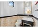Elegant powder room featuring stone tile accents, modern fixtures, and stylish design at 4128 Causeway Vista Dr, Tampa, FL 33615