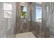 Tiled shower with two windows and a white tiled floor at 4128 Causeway Vista Dr, Tampa, FL 33615