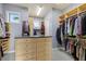 A spacious walk-in closet features custom wooden shelving and built-in storage at 4128 Causeway Vista Dr, Tampa, FL 33615