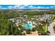 An aerial shot shows the community amenities: pool, lake, tennis courts, and meticulously maintained landscaping at 4155 Barletta Ct, Wesley Chapel, FL 33543