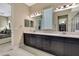 Full bathroom features double vanity, lots of storage, walk-in closet, and bright lighting at 4155 Barletta Ct, Wesley Chapel, FL 33543