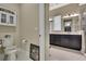 Half bath leading to modern bathroom with large vanity, great lighting, and plenty of storage at 4155 Barletta Ct, Wesley Chapel, FL 33543