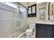 Updated bathroom showcasing glass enclosed shower, cabinet storage, and updated decor at 4155 Barletta Ct, Wesley Chapel, FL 33543