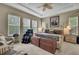 Spacious bedroom featuring a ceiling fan, natural light, and cozy decor at 4155 Barletta Ct, Wesley Chapel, FL 33543