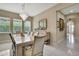 Elegant dining room with a chandelier, a large table, and bright windows at 4155 Barletta Ct, Wesley Chapel, FL 33543