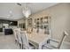 Elegant dining room boasts a stylish chandelier, dining table, and a glass display cabinet at 4155 Barletta Ct, Wesley Chapel, FL 33543