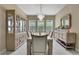 Formal dining room with a crystal chandelier, display cabinet, and seating for eight at 4155 Barletta Ct, Wesley Chapel, FL 33543