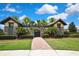 Charming entry to a community featuring manicured landscaping, a red brick walkway, and stone architecture at 4155 Barletta Ct, Wesley Chapel, FL 33543
